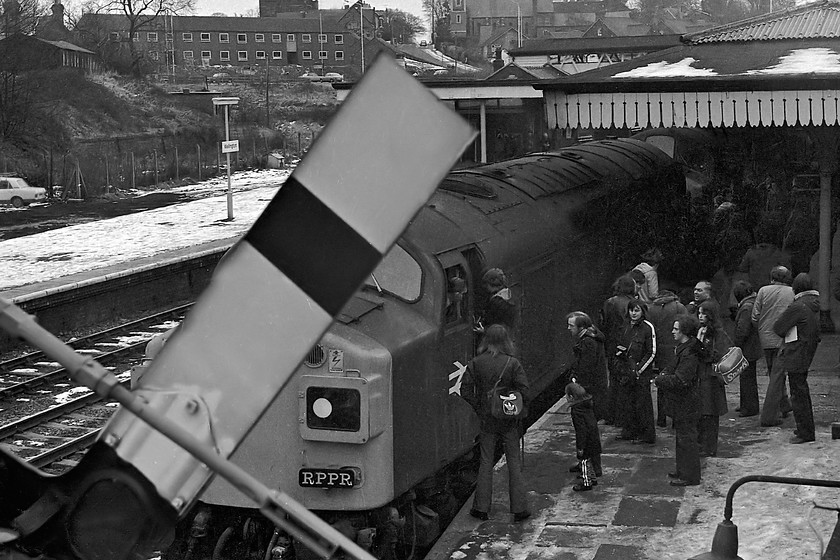 40144 & 40113, outward leg of The Crewe Campaigner Relief, 07.35 London Paddington-Crewe (1Z68), Wellington station 
 As the photo-stop at Wellington was coming to an end, I dashed out of the station and up Station Road and leant over the retaining wall to get this picture. It shows 40144 and 40113 at the head of The Crewe Campaigner Relief railtour. Cabbing of the leading 40 is still taking place so I still had plenty of time to get back on to the platform and re-join the train. It's a shame that the semaphore is arm is out of focus. As it was such a dull morning the aperture on the Helios lens on the Zenith EM camera was probably pretty wide open giving very little depth of field. Notice the Mk. II Ford Cortina looking a bit lonely on the old wasteland in the background. This area of land was once the goods yard and had a number of sidings, it is now a huge station car park; a symptom of changing times I suppose. 
 Keywords: 40144 40113 The Crewe Campaigner Relief 07.35 London Paddington-Crewe 1Z68 Wellington station.