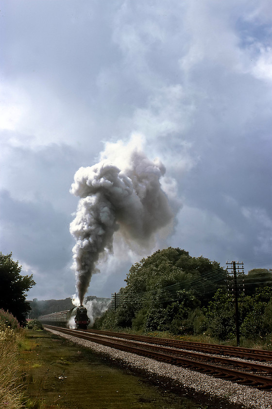 4472, outward leg of The North Yorkshireman, Carnforth-Skipton, Wennington SO625700 
 With an explosive display of exhaust, 4472 'Flying Scotsman' gets the outward leg of The North Yorkshireman railtour underway after its stop at Wennington. The departure was a slow and rather careful one with a number of dramatic and violent wheel slips. The slight backlighting from the sun and the cloudy sky has really emphasised the towering display from Scotsman. Notice to the left the land where the former loop and sidings were located that were installed during World War Two. This picture is courtesy of Mr. Graham Vincent. 
 Keywords: 4472 outward leg of The North Yorkshireman Carnforth-Skipton Wennington SO625700