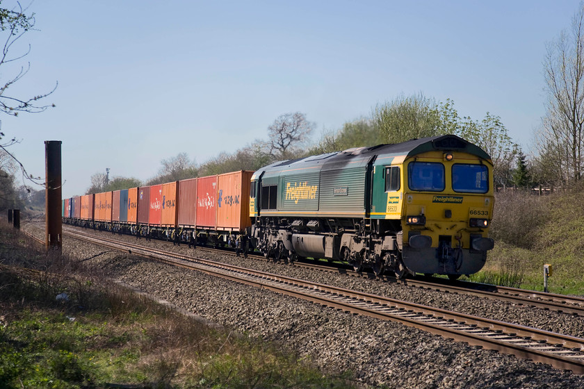 66533, 11.00 Bristol Freightliner Terminal-Tilbury (4L32), Knighton crossing SU276890 
 On this warm spring afternoon, the driver of 66533 'Hanjin Express/Senator Express' has left his cab door open for a little extra ventilation. The locomotive is leading the daily 11.00 Bristol Freightliner Terminal to Tilbury 'liner working and is seen passing the site of the former level crossing at Knighton in west Oxfordshire. 
 Keywords: 66533 11.00 Bristol Freightliner Terminal-Tilbury 4L32 Knighton crossing SU276890 Hanjin Express/Senator Express