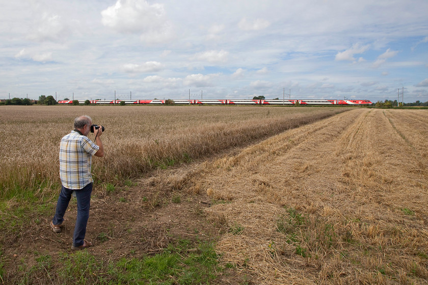 Andy & 91104, GR 10.35 London Kings Cross-Leeds (1D10, RT), Holme Green TL193422 
 Looking across a half harvested field at Holme Green just south of Huntingdon, Andy photographs the 10.34 King's Cross to Leeds. Close examination of the image reveals that it is being led by 91104. Notice that just as we were drawing our morning out to a close, the sun decided to put in an appearance! 
 Keywords: Andy 91104 1D10 Holme Green TL193422