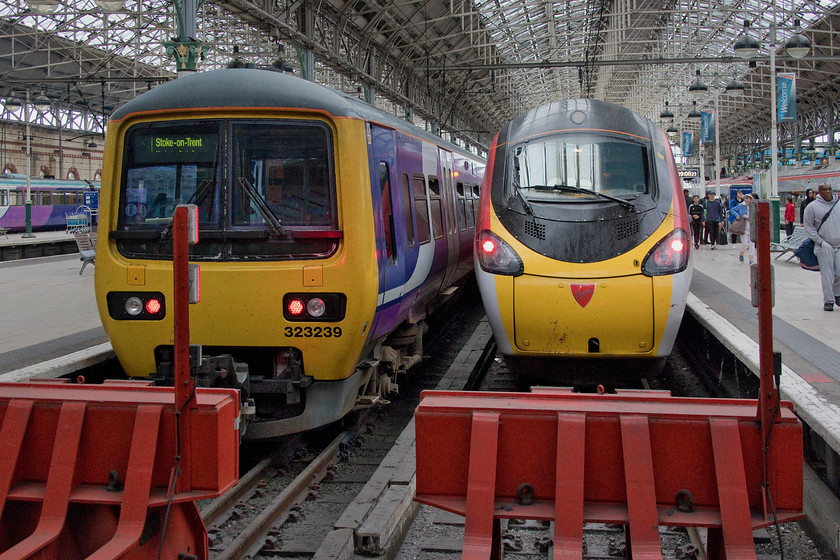 390130, VT 06.55 London Euston-Manchester Piccadilly (1H08, 1L) & 323239, NT 09.44 Manchester PIccadilly-Stoke-on-Trent (2K10, 2L), Manchester Piccadilly station 
 Having brought us up from Milton Keynes, 390130 'City of Edinburgh' rests on the blocks at Manchester Piccadilly with the 1H08 06.55 ex London Euston. On the adjacent platform, 323130 will work the 09.44 to Stoke-on-Trent. In theory, these early 1990s EMUs should have gone off-lease being replaced by the CAF class 331s. However, as usual, delays have dogged this plan and at the point that this photograph was taken, only a few of the new units were in-service. 
 Keywords: 390130 06.55 London Euston-Manchester Piccadilly 1H08 323239 09.44 Manchester Piccadilly-Stoke-on-Trent 2K10 Manchester Piccadilly station