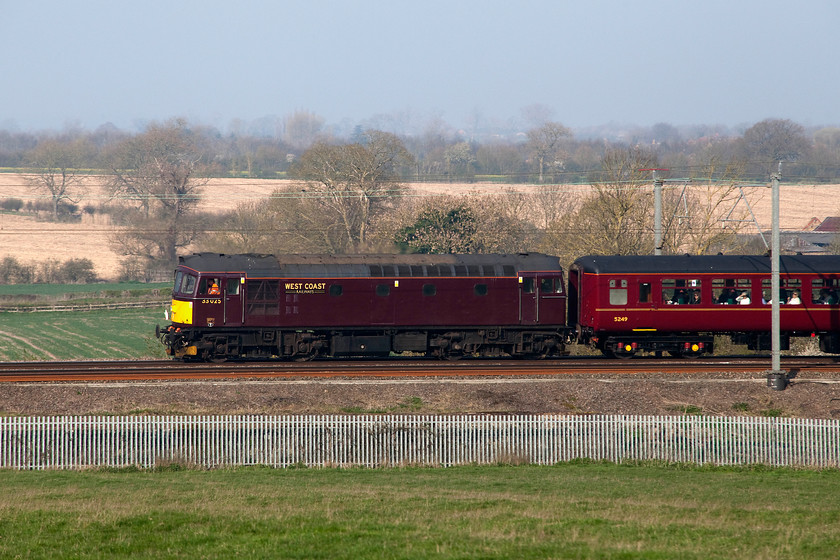 33025, outward leg of Steam Dreams Excursion, 07.10 London Euston-Worcester Shrub Hill (1Z60), Milton Malsor SP739562 
 Veteran type 3 33025 (ex D6543) brings up the rear of the Steam Dreams Excursion that started out from Euston at 07.10 with LNER B1 61306 'Mayflower' leading. The Class 33 looks about as good as it can get in its rather drab West Coast Railway's livery having recently undergone a complete overhaul and considerably better than when I photographed it back in 1980 at a drab and wet bath Spa, see..... https://www.ontheupfast.com/p/21936chg/26118464804/x33025-steam-dreams-excursion-07 The train, that ended up at Worcester Shrub Hill, is seen passing Milton Malsor just south of Northampton. 
 Keywords: 33025 Steam Dreams Excursion 07.10 London Euston-Worcester Shrub Hill 1Z60 Milton Malsor SP739562