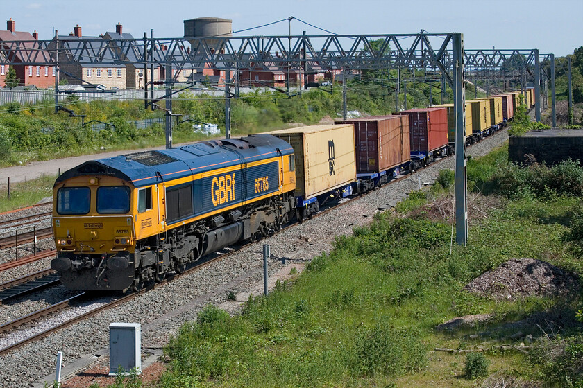 66785, 13.33 Wembley Reception-Hams Hall (4G13, 37L) (ex London Gateway, 4M12), site of Roade station 
 With the Northampton loop closed for engineering works the little freight that was scheduled to pass through the lower end of the WCML was forced to take the Weedon loop known as the 'old route'. 66785 is seen passing Roade nearly three-quarters of an hour late with the re-scheduled 13.33 Wembey Reception to Hams Hall service running as 4G13. This should have originated from London Gateway and run throughout as 4M12 but something obviously went wrong earlier in the day. 
 Keywords: 66785 13.33 Wembley Reception-Hams Hall 4G13 London Gateway 4M12 site of Roade station GBRf Freightliner