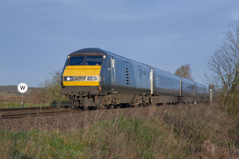 82301, CH 07.12 Kidderminster-London Marylebone (1H10), King's Sutton 
 DVT 82301 leads the 07.12 Kidderminster to London Marylebone approaching King's Sutton. I like the 'silver bullet' style livery adopted by Chiltern on their stock and locomotives. As it is the last weekend in November the sun is very low in the sky and causing some vision issues for the driver witnessed by the sun visors extended over halfway down the screens. 
 Keywords: 82301 07.12 Kidderminster-London Marylebone 1H10 King's Sutton