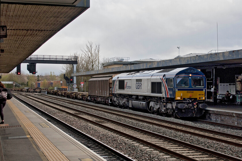 66780, 12.18 Marchwood MoD-Bicester MoD (6V44, 19E), Oxford station 
 I was delighted to see 66780 'The Cemex Express' pass through Oxford station as it was a photographic cop! It's such as shame that the picture is of such mediocre quality due to the rushed composition and the abysmal lighting! The unique livery carried by the GB Railfreight Class 66 certainly brightens things up a bit! The working is the 6V44 Marchwood to Bicester MoD train that seems to be conveying very little in its consist on this occasion. 
 Keywords: 66780 12.18 Marchwood MoD-Bicester MoD 6V44 Oxford station The Cemex Express