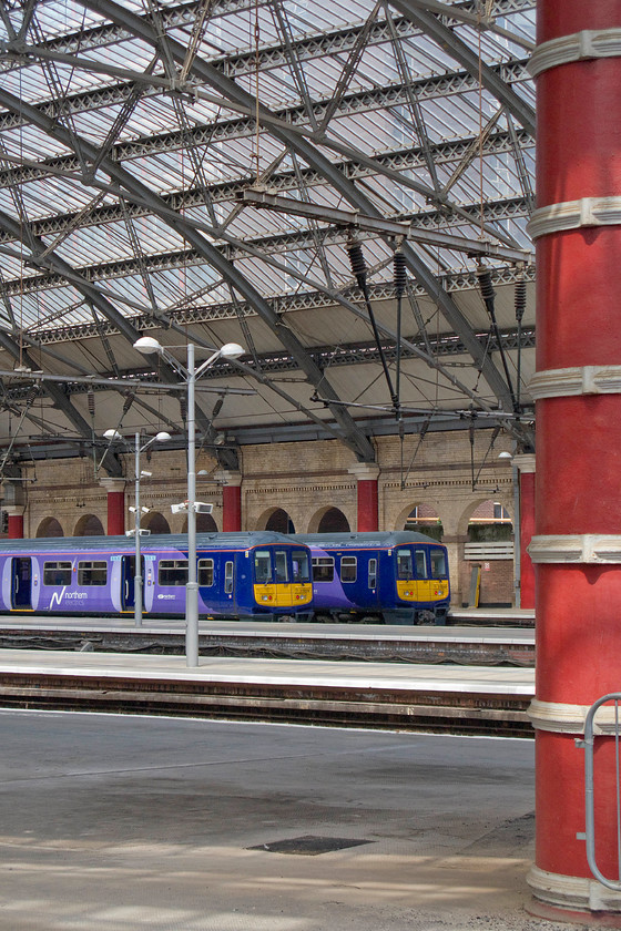 319374, NT 13.20 Liverpool Lime Street-Manchester Victoria (2J36) & 319369, NT 13.16 Liverpool Lime Street-Manchester Airport (1H49), Liverpool Lime Street station 
 A pair of former Thameslink class 319s wait under the impressive ironwork of Liverpool Lime Street in their new and shiny Northern Trains paint scheme. To the left, 319374 will work the 2J36 13.20 to Manchester Victoria whilst 319369 will form the 1H49 13.16 to Manchester Airport. Despite them being stopgap units until the arrival of the new Civity Class 331s the standard of refurbishment is impressive being considerably more than a quick repaint. 
 Keywords: 319374 13.20 Liverpool Lime Street-Manchester Victoria 2J36 319369 13.16 Liverpool Lime Street-Manchester Airport 1H49 Liverpool Lime Street station