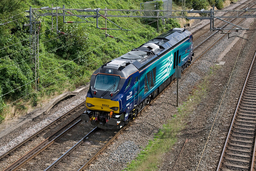 68002, 12.33 Wembley Yard-Crewe Gresty Bridge LE (0Z68), Victoria bridge 
 This is my first photograph of 68002 'Intrepid' since its introduction earlier this year. Still wearing its smart and shiny paintwork it is seen passing Victoria bridge between Roade and Ashton on the southern WCML running as 0Z68 the 12.33 Wembley to Crewe Gresty Bridge light engine. I am not at all sure if I like the look of these new Vossloh Espaa built locomotives finding them a little clumsy in their design. 
 Keywords: 68002 12.33 Wembley Yard-Crewe Gresty Bridge 0Z68 Victoria bridge Intrepid