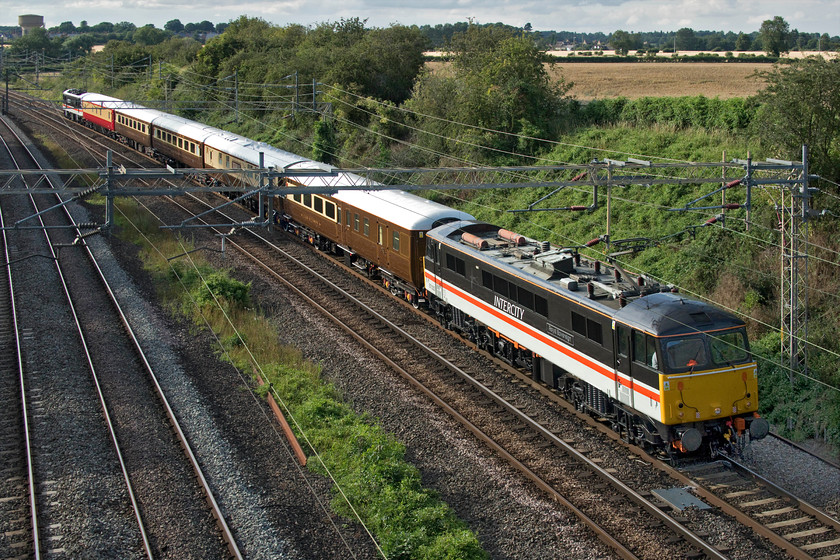 87002 & 90002, 15.35 Crewe HS-Euston (5Z90, RT), Victoria bridge 
 Being the first company to restart its charter programme after the enforced COVID-19 mass cancellations is quite an accolade. Saphos Trains, part of LSL in Crewe, will be running that first charter tomorrow (15.07.20) going up and over the S&C to Carlisle with 70000 'Britannia' doing the honours. In preparation for this important and significant event, Saphos ran a test train of the stock from Crewe to London and back running as 5Z90. It is being led by its recently repainted 87002 'Royal Sovereign' looking superb in its InterCity Swallow livery. 90002 'Wolf of Badenoch' is at the rear with some high-quality stock sandwiched in between. The smart train is seen passing Victoria bridge just south of Roade in Northamptonshire. Saphos is a relative newcomer to the potentially lucrative charter market. With locomotives and stock looking like this I suspect that it will do well! 
 Keywords: 87002 90002 15.35 Crewe HS-Euston 5Z90 Victoria bridge Royal Sovereign Wolf of Badenoch