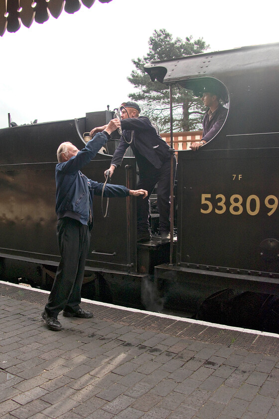 Exchanging the tokens, 53809, 10.45 Holt-Sheringham, Weybourne station 
 As 53809 arrives tender first at Weybourne station the driver and the signalman exchange their tokens in a practice perfect manner! The S & D 7F is working the 10.45 Holt to Sheringham service with the balancing service worked by a Class 101 DMU out of sight on the other platform. Interestingly, a number of these sturdy and robust locomotives were actually designed to run tender first for many of their journeys when in service from new on the Somerset and Dorset line as they were too long for the railway's turntables until the railway acted on this. I can imagine that running from Bath to Bournemouth back in the 1920s tender first was not a pleasant experience for the driver and fireman especially during inclement weather! 
 Keywords: Exchanging tokens 53809 10.045 Holt-Sheringham Weybourne station 7F Somerset and Dorset S & D