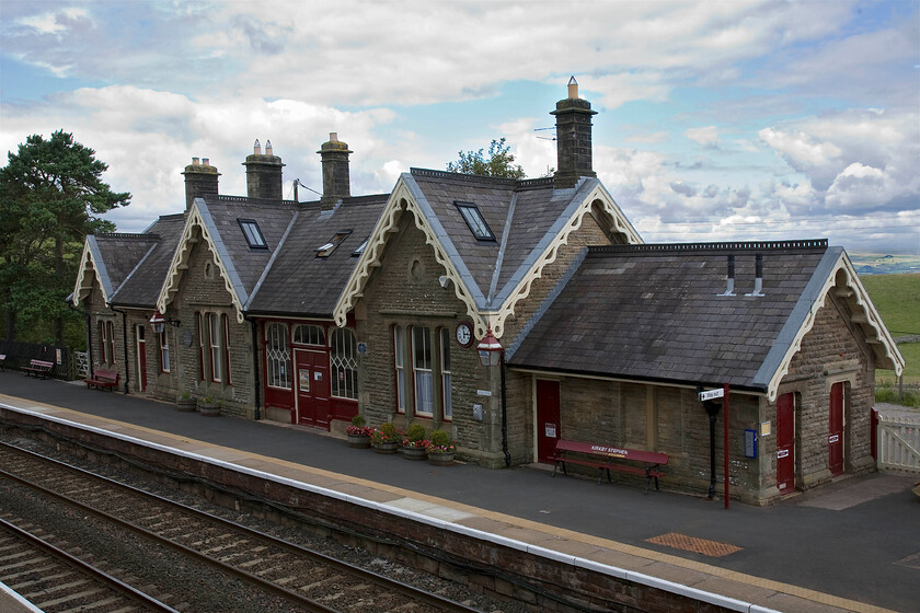 Kirkby Stephen station 
 Kirkby Stephen station building is a classically designed structure on this route being penned by John Holloway Sanders for the Midland Railway. It is located somewhat inconveniently for the nearby town being over a mile and one hundred and fifty feet above it! This was in an effort to keep the gradient of the line within planned limits with the town better served by Kirkby Stephen East station on the North Eastern Railway's Stainmore and Eden Valley lines that was shut in 1964 much to the chagrin of the local residents no doubt! Today, the station is owned and managed by the Settle and Carlisle Railway Trust, which comprehensively restored it in 2009. 
 Keywords: Kirkby Stephen station