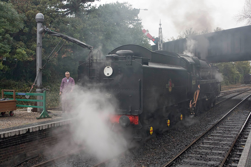 92203, taking water, Sheringham staton 
 92203 'Black Prince' takes water at Sheringham station. It was a foul afternoon with the steam escaping from the 9F condensing in the damp autumnal air. 92203 was about to work the 12.10 Sheringham to Holt service that included The North Norfolkman dining train. 
 Keywords: 92203 taking water Sheringham staton