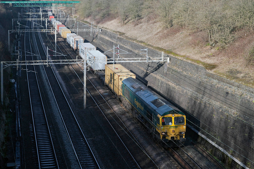 66529, 12.28 Daventry-Wembley Freightliner, Roade Cutting 
 66529 toils on the upgrade through Roade Cutting with the Sunday only 12.28 Daventry to Wembley Freightliner. Even though it's now early afternoon the sunlight is disappearing fast from the depths of Roade Cutting. 
 Keywords: 66529 Freightliner Roade Cutting