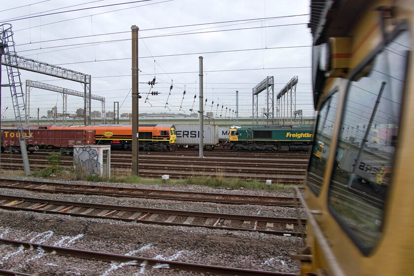 59206, 66590 & Class 66, Wembley Yard 
 Class 59s are more normally associated with the West Country and the haulage of heavy stone trains. However, these trains do make forrays wider afield as seen here in Wembley Yard with 59206 stabled between workings. Mike's TOPS report did not identify its inbound working but later in the day, it would lead the 7C77 12.19 empty stone working back to Merehead Quarry. According to TOPS 66590 was on a London Gateway Freightliner service and as for the Class 66 with some interesting reflections in its windscreen, who knows? 
 Keywords: 59206, 66590 & Class 66, Wembley Yard