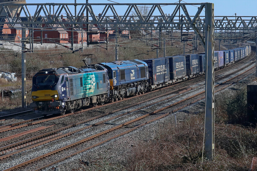 88008 & 66427, 08.43 Tilbury FLT-DIRFT (4M07, 3E), site of Roade station 
 Failure of a locomotive or a move by design? The 4M07 08.43 Tilbury to DIRFT down Tesco Express passes Roade on another glorious early spring afternoon. Leading is 88008 'Ariadne' with 66427 tucked in behind. This shot was almost spoilt by a down Avanti service which was bearing down on me and is seen just in-shot to the extreme right of the frame. 
 Keywords: 88008 66427 08.43 Tilbury FLT-DIRFT 4M07 site of Roade station Tesco Express DRSAriadne