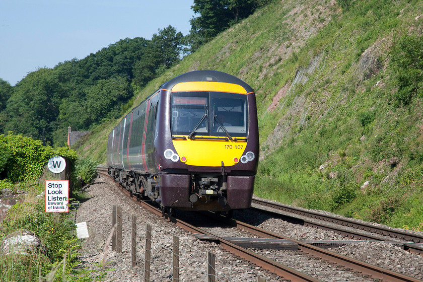 170107, XC 06.58 Nottingham-Cardiff Central (1V04, 1E), Gatcombe SO682055 
 170107 crosses the foot crossing near Gatcombe next to the River Severn in Gloucestershire. Given that this was such a remote spot and one that required a strenuous walk, I was surprised that there were four photographers present! This made it a little crowded on small a hillock that seemed to be one giant ants' nest! 
 Keywords: 170107 1V04 Gatcombe SO682055