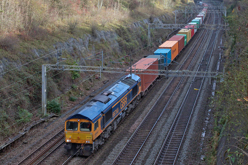 66768, 10.34 Felixstowe North-Hams Hall (4M23, 4E), Roade cutting 
 Cop number one.......66768 leads the 4M23 Felixstowe to Hams Hall Freightliner through Roade cutting. This GBRf locomotive is a photographic cop so it's a shame that it is in the deep shadows in the depths of the cutting. 
 Keywords: 66768 10.34 Felixstowe North-Hams Hall 4M23 Roade cutting