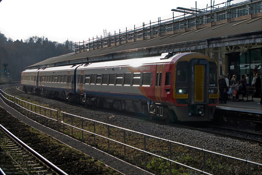 159012, SW 15.51 Bristol Temple Meads-London Waterloo (1O60), Bath Spa station 
 In very awkward lighting 159012 arrives at Bath Spa station forming the 15.51 Bristol to London Waterloo service. South West have three variants of their liveries that illustrate the type of services that the particular train is dedicated to. In this case, 159012 bears a large white area to its flank indicating that this unit is designated a 'long distance' unit. I can understand why SWT operate to and from Exeter via Salisbury but I do find the Bristol to Waterloo services a little odd. I have not been able to find out the history of these services and why they form a part of their franchise agreement. 
 Keywords: 159012 15.51 Bristol Temple Meads-London Waterloo 1O60 Bath Spa station South West Trains