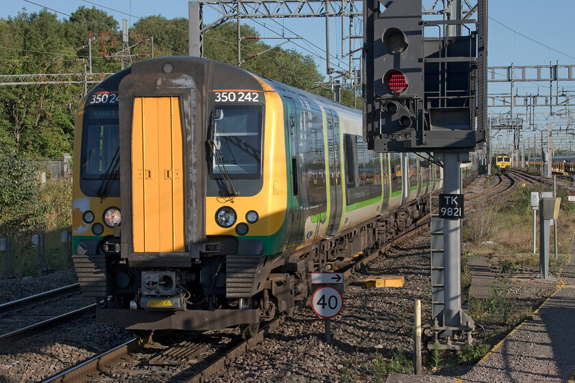 350342, LN 08.25 Northampton-London Euston (1Y10, RT), Bletchley station 
 The 08.25 Northampton to Euston service arrives at Bletchley station worked by 350342 and another unidentified unit at the rear. Notice the ONE liveried 66587 'As One, We Can' in the adjacent siding. This was leading the previous evening's 4L96 that had been halted at this location and remained there for five days. 
 Keywords: 350342 08.25 Northampton-London Euston 1Y10 Bletchley station London Northwestern Desiro