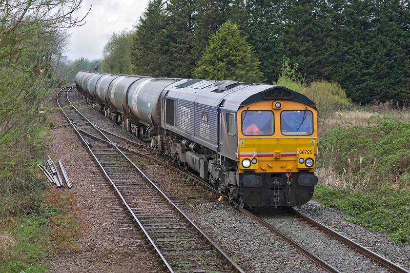 66725, 09.57 Harwich Refinery-North Walsham tankers (6P41), Whitlingham Lane crossing TG266083 
 A regular freight flow over the Sheringham branch as far as North Walsham at least is the empty condensate tanks from Harwich. The train goes to North Walsham to be filled with the highly flammable liquid that is a by-product of the production of North Sea natural gas that is piped ashore and processed at the large Bacton terminal some four miles from Walsham. 66725 'Sunderland' leads the empties on the approach to Norwich's Whitlingham Junction. Notice the wiper in mid-sweep as the drizzle from earlier had now turned to some more determined rain! 
 Keywords: 66725 09.57 Harwich Refinery-North Walsham tankers 6P41 Whitlingham Lane crossing TG266083 Sunderland GBRf