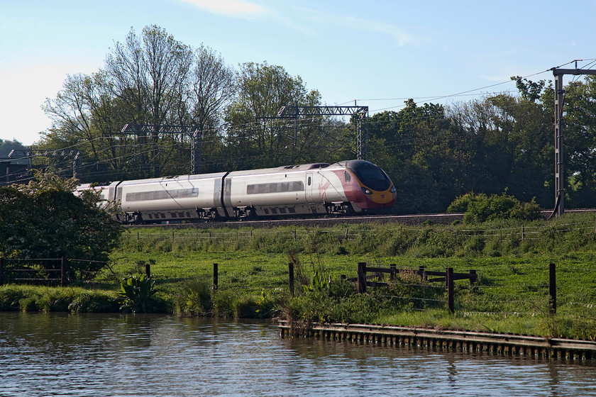 390157, VT 06.55 London Euston-Manchester Piccadilly (1H08, RT), Bugbrooke SP679564 
 Despite the sun shining and a clear blue sky looks can be deceiving. It was in-fact very chilly down by the Grand Union Canal and there were just hints of a little light frost on the grass despite it being nearly the end of May! 390157 'Chad Varah' heads north by the canal near to Bugbrooke in Northamptonshire with the 06.55 Euston to Manchester Piccadilly 1H08 working. 
 Keywords: 390157 1H08 Bugbrooke SP679564