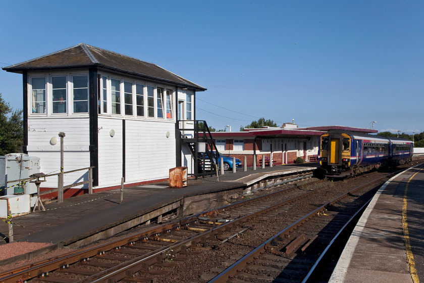 156450, SR 09.00 Girvan-Ayr (1A57, RT), Girvan station 
 In beautiful weather, 156450 is about to leave Girvan with the 09.00 to Ayr. This train had just arrived from Ayr and does a quick turn round after the driver took a breif PN break. To the left is the G&SW 1893 signal box that controls a fairly complex area of track and signalling. 
 Keywords: 156450 09.00 Girvan-Ayr 1A57 Girvan station