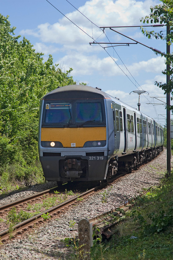 321319, LE 11.48 London Liverpool Street-Braintree (1F22, 13L), White Notley 
 In tricky lightning, 321319 arrives at White Notley station working the 11.48 Liverpool Street to Braintree. The train is about to cross the level crossing situated immediately prior to the single platform station. Unlike the nearby Sudbury branch, the Braintree one is electrified and enjoys direct services from London, as in the case of this service. 
 Keywords: 321319 1F22 White Notley