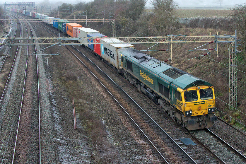 66572, 05.00 Trafford Park-Felixstowe North (4L75, 8L), Victoria bridge 
 Having just missed the northbound 4M94 by a matter of a minute or two I just managed to capture the 4L75 05.00 Trafford Park to Felixstowe Freightliner service. 66572 is seen hauling the train past a cold Victoria bridge just south of Roade. After a few lean weeks when many freight trains were hauling a lot of fresh air, this one, and most of the others seen today, were well loaded. With the start of the New Year, it looks like Freightliner has finally finished with the Class 86s. This turn was a regular for the vintage locomotives up until a week or so ago. There appears to be no services now scheduled for haulage by doubled headed AL6 but with no official announcement, time will tell! 
 Keywords: 66572 05.00 Trafford Park-Felixstowe North 4L75 Victoria bridge Freightliner