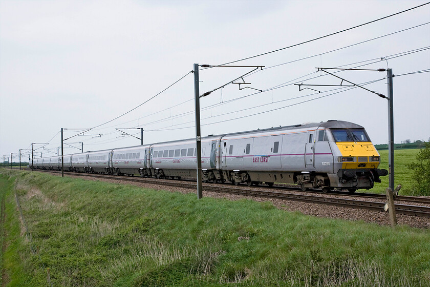 82230, GR 15.05 Leeds-London King's Cross (1A37), Frinkley Lane crossing SK906436 
 In a matching East Coast livery, the 15.05 Leeds to King's Cross 1A37 service races past Frinkley Lane level crossing on a dull may Bank Holiday weekend. It is led by DVT 82230 with an unidentified Class 91 powering at the rear. It warms me to see a state-owned and operated express dong what it should be doing and only goes to reassure me that one day this crazy franchising system that we have in this country will come to end and common sense prevails! 
 Keywords: 82230 15.05 Leeds-London King's Cross 1A37 Frinkley Lane crossing SK906436