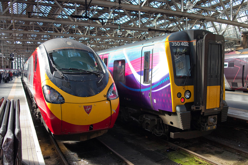 390123, VT 10.40 Glasgow Central-London Euston (1M11) & 350402, SR & TP 11.09 Glasgow Central-Manchester Airport (1M96), Glasgow Central station 
 Two up services wait to leave a sunny Glasgow Central station. To the left, 390123 is nearly ready to go with the 10.40 1M11 to London Euston. To the right, 350402 will leave in about thirty minutes time with the 11.09 to Manchester Airport. 
 Keywords: 390123 10.40 Glasgow Central-London Euston 1M11 350402 11.09 Glasgow Central-Manchester Airport (1M96) Glasgow Central station