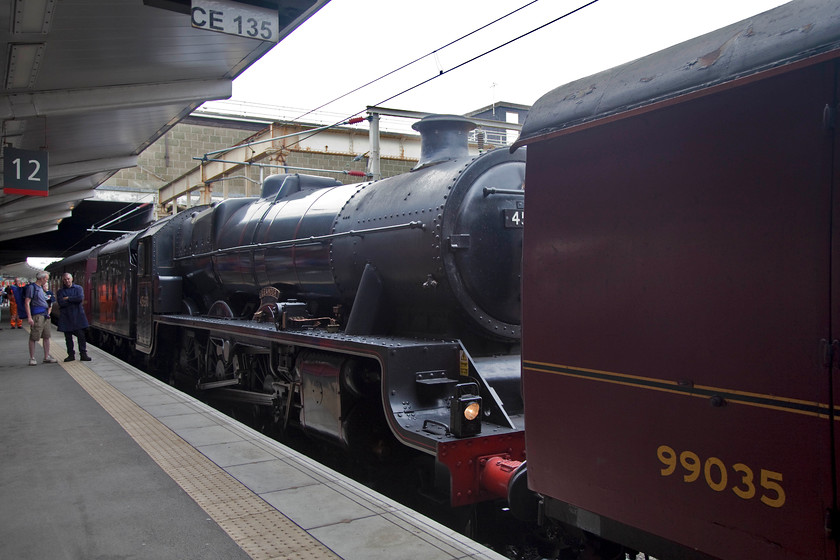 45690, taking water, Crewe station 
 The rear end of an interesting locomotive move seen on platform 12 at Crewe station. 45690 'Galetea' is seen at the back of a formation containing 37706, 44781 and two support coaches. 44781 and the 37 were to continue on to Bristol with 45690 being detached here at Crewe after both steam locomotives took water at the platform. Unfortunately, due to the intense dry summer of 2018, steam was banned on the network from running on its own so all needed a diesel pilot hence the class 37 leading the working that ran as 5Z50. 
 Keywords: 45690 Crewe station