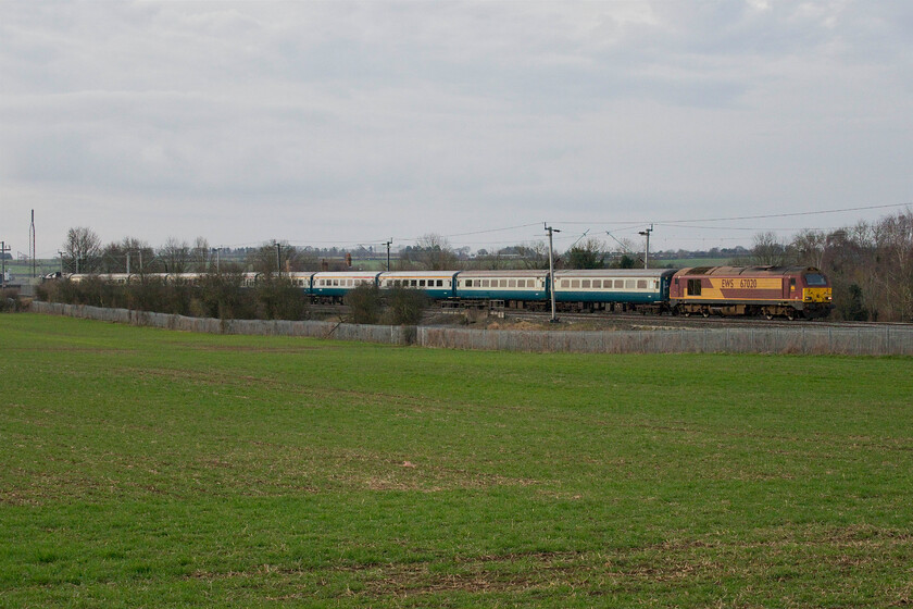 67020, outward leg of 'The Powerful Pennine Panorama', 07.00 London Euston-Leeds (1Z79, 2E), Milton Malsor SP741557 
 Unfortunately, the bright start promised by the Met. Office did not materialise with a cloudy and grey morning instead so the spot that I chose to photograph the outward 1Z79 charter from Euston to Leeds was not actually required! Also, I was hoping that the oddly named 'Powerful Pennine Panorama', led by 67020 would have fitted in the gap that I had identified but, as can be seen, 67005 'Queen's Messenger' is blocked from view at the rear of the train by small trees that have grown significantly since I last visited this location near to the village of Milton Malsor near Northampton. 
 Keywords: 67020 'The Powerful Pennine Panorama' 07.00 London Euston-Leeds 1Z79 Milton Malsor SP741557 EWS