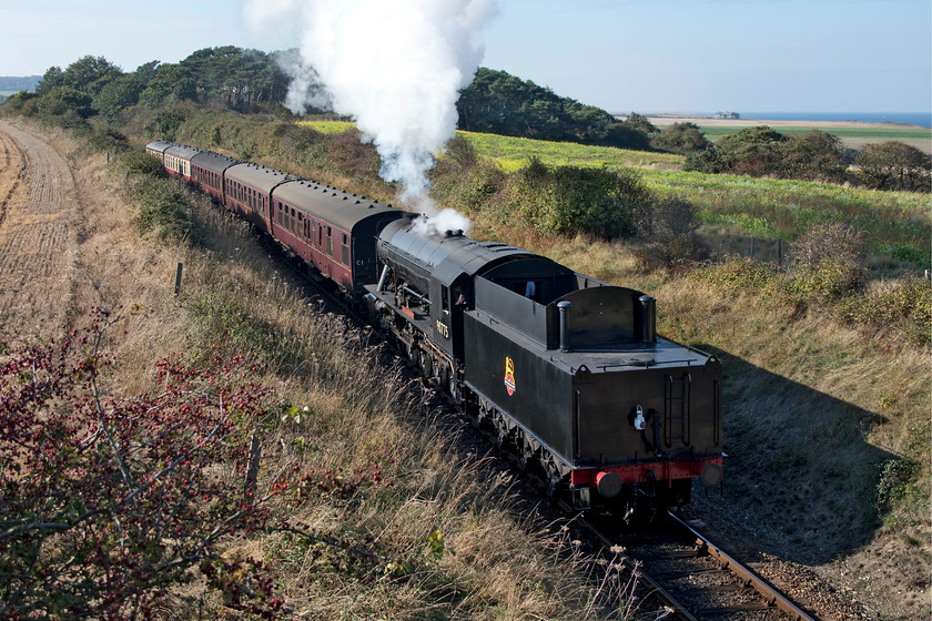 90775, 13.05 Holt-Sheringham, Dead Mans Hill 
 During our walk to Sheringham, my son and I reached Dead Man's Bridge just as the 13.00 Holt to Sheringham train came past. WD 2-10-0 90775 'The Royal Norfolk Regiment' is seen leading the train tender first on this superb autumn afternoon. 
 Keywords: 90775 13.05 Holt-Sheringham Dead Mans Hill