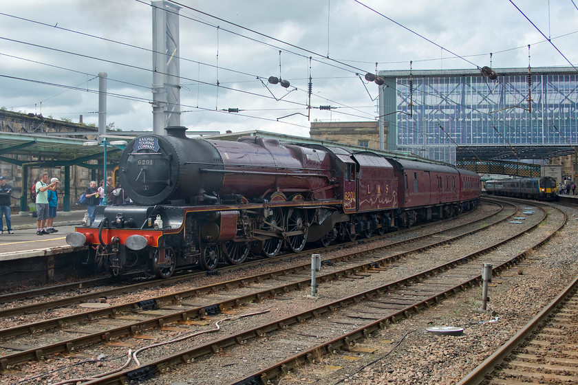 20. 6201, return leg of The Cumbrian Mountain Express, 15.20 Carlisle-Crewe (1Z25), Carlisle station 
 As well as the open day at DRS Kingmoor there were also two steam-hauled railtours at Carlisle, thus there were many enthusiasts around the station. Whilst not many are seen crowding around 1933 Crewe built 4-6-2 locomotive, behind where I am standing there were plenty! 6201 'Princess Elizabeth' will soon lead the returning Cumbrian Mountain Express from Carlisle at 15.20 to Crewe. This tour took the WCML route south over Shap, something that these Staniers were designed to do and should handle with relative ease. 
 Keywords: 6201 The Cumbrian Mountain Express 15.20 Carlisle-Crewe 1Z25 Carlisle station