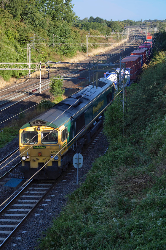 66565, 03.25 Garston-London Gateway (4L52), Victoria Bridge 
 With just the bridge of its nose poking out from the shadows, 66565 leads the 03.25 Garston to London Gateway past Victoria Bridge. London Gateway is a large freight terminal near to Stanford-le-Hope in Essex that opened in 2013. 
 Keywords: 66565 03.25 Garston-London Gateway 4L52 Victoria Bridge