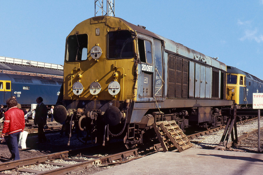 47465, 20097 & 47405, on-display, Crewe Works 
 20097 is at Crewe for repairs after sustaining accident damage. The recessed space on the cabside is indicative that it was built as a Scottish Region locomotive with space once containing automatic tablet exchange equipment. The roped up door, chalked message and the strategically placed pallets are making the message abundantly clear to visitors! The class 20 survived in traffic for exactly another ten years having been withdrawn and reinstated in 1981 and 1982 respectively. In the background is 47465 at Crewe for repairs. Behind the 20 is 47405, an Eastern Region locomotive throughout its life. This is a significant member of the class in that it was the first 47 to be withdrawn other than for 'uneconomical repair' reasons. In other words, the first member of this class to be withdrawn as part of BR's planned run-down programme for the class. 
 Keywords: 47465 20097 47405 on-display Crewe Works