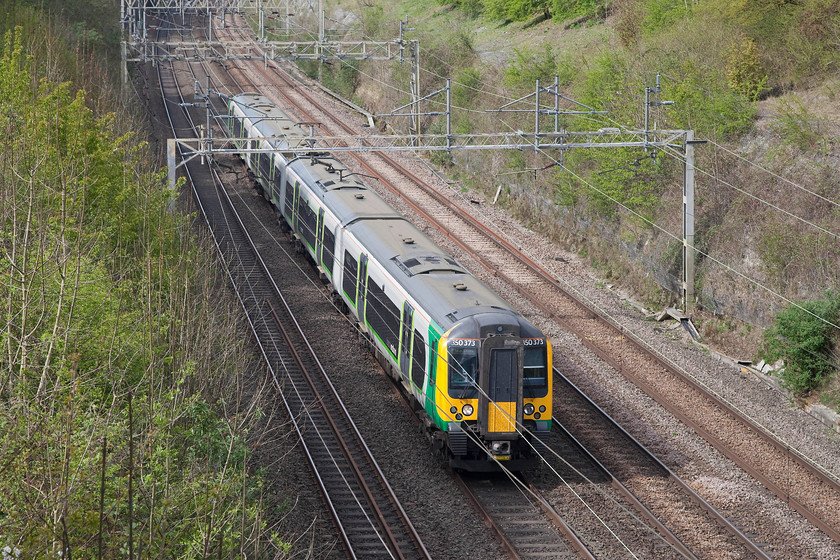 350373, LM 13.02 Crewe-London Euston (1U32, RT), Hyde Road bridge 
 350373 takes the up fast through Roade Cutting about to pass under Hyde Road bridge. It is forming the 13.02 Crewe to London Euston working. I like the low but increasingly strong sun of early spring; it gives a special quality of light that I think really enhances images. 
 Keywords: 350373 1U32 Hyde Road bridge