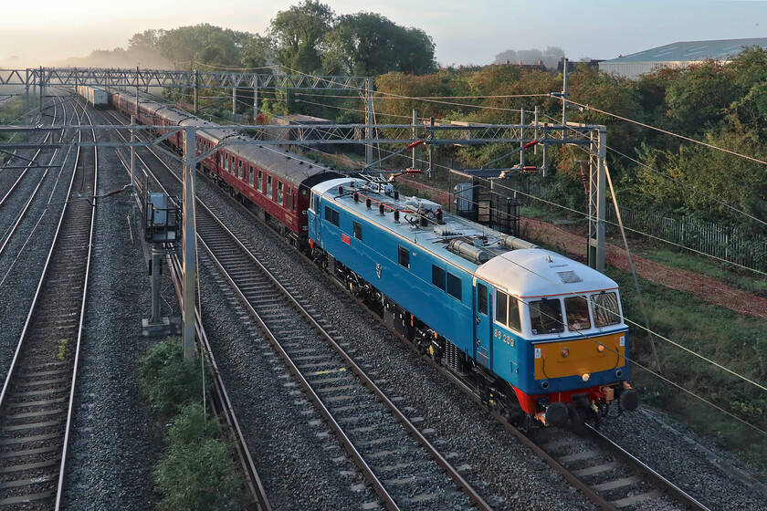 86259, outward leg of The Cumbrian Coast Express, 06.48 London Euston-Carlisle (1Z86, 11E), site of Roade station 
 With the 4L97 Freightliner safely out of the way at Roade 86259 'Peter Pan/Les Ross' passes at speed heading north leading the 1Z86 Cumbrian Coast Express. I love the lighting in this photograph with the rising sun just glinting on the side of the train with the September morning mists still hanging about in the distance. On arrival at Carlisle, the train would be steam hauled around the delightful and dramatic Cumbrian Coast route by 45690 'Leander' as far as Carnforth where 86259 would take the train back to Euston. 
 Keywords: 86259 The Cumbrian Coast Express, 06.48 London Euston-Carlisle 1Z86 site of Roade station es Ross Peter Pan