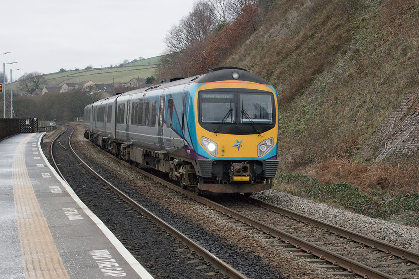 185128, TP 12.19 Manchester Airport-Newcastle (1P25, RT), Slaithaite station 
 Having crossed the Pennines, 185128 descends through the Colne Valley with the 12.19 Manchester Airport to Newcastle working that will soon stop at Huddersfield. Just beyond the station is Slaithaite's 17-arch viaduct, a feature that dominates the landscape around the small town. 
 Keywords: 185128 12.19 Manchester Airport-Newcastle 1P25 Slaithaite station