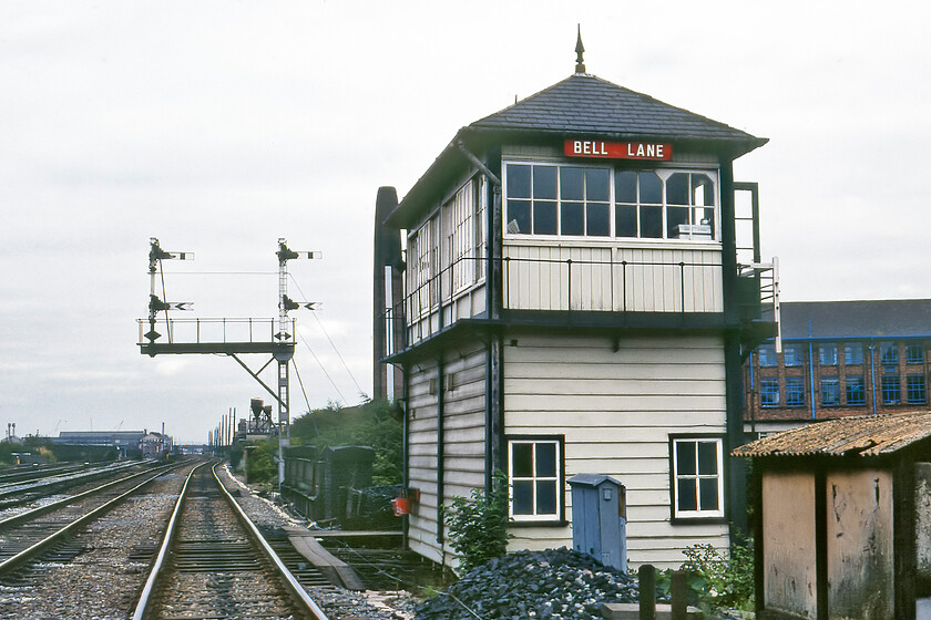 Bell Lane signal box (MR, 1891) 
 Quite how I managed the gall to stand in the middle of the up goods line to take this photograph of Leicester's Bell Lane signal box is lost on me now! I do not think that I had permission so it would have been a case of setting the camera up, checking for trains and nipping on to the track before the signalman had a chance to notice what was going on and take the photograph! The box is a fine example of Midland Railway Type 2b design that was opened in 1891 but has the unusual design feature of the access steps to the rear. It wears its LMS post-1935 wooden nameboard and has a couple of fire buckets hanging on the front. The box was closed in the summer of 1985 when the Syston Junction to Market Harborough MAS scheme was commissioned. 
 Keywords: Bell Lane signal box MR Midland Railway