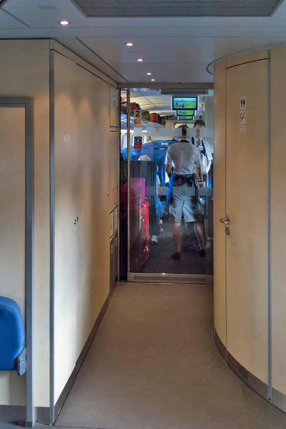 Vestibule & coach,-EVS1-12, 13.00 St. Petersburg-Moscow (765A), leaving Tver station 
 Looking down the coach inside Sapsan EVS1-12 from the vestibule reveals the extra width afforded by the generous Russian loading gauge. The trains, whilst having their speed capped at 155mph due to running on classic lines, may not offer the fastest 'hi-speed' services but were excellent. The speed was deceptive, indeed, I checked on my 'phone a number of times that we were at the advertised speed and, indeed, we were. The seats were roomy and very comfortable but the advertised wi-fi was all but useless, indeed, I gave up attempting to work on this web site and reverted to window gazing largely at the lines and lines of trees in view across the flatlands between St. Petersburg and Moscow. 
 Keywords: Vestibule coach EVS1-12 13.00 St. Petersburg-Moscow 765A Tver station