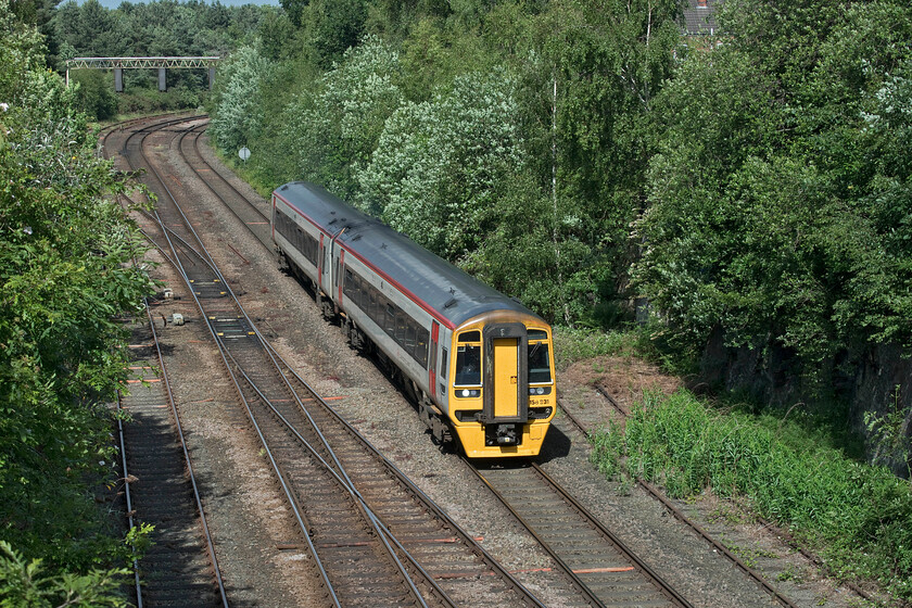 158831, AW 14.34 Holyhead-Cardiff Central (1V97, 3L), Northgate Arena car park 
 This view from Chester's Northgate Arena car park would once have been somewhat different with two bridges crossing the railway below. These two bridges carried railway tracks from Chester Northgate's small depot back to the 'mainline' that curved away towards Mickle Trafford. I am actually standing on the trackbed of the lines that came from the good's shed with the lines into Northgate station behind me. 158831 is seen leaving Chester General (a short distance around the curve in the background) with the 14.34 Holyhead to Cardiff Central service. 
 Keywords: 158831 14.34 Holyhead-Cardiff Central 1V97 Northgate Arena car park TfW Transport for Wales