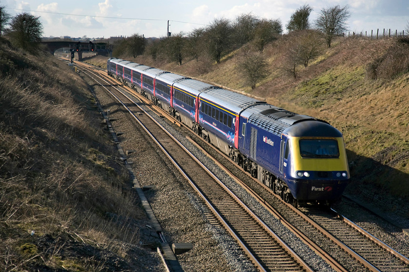 43124, GW 12.28 Swansea-London Paddington (1L62), Steppingstone Lane, Bourton SU234875 
 The bridge on which I am standing is a farm occupation bridge that carries Steppingstone Lane near the west Oxfordshire village of Bourton. This is a delightful spot that I could have spent hours at that afforded unobscured views of the GWML in both directions. Unfortunately, this will soon be ruined forever as the electrification masts and wiring arrive. 43124 leads the 12.28 Swansea to Paddington past the spot with the low winter sun creating some long shadows. 
 Keywords: 43124 12.28 Swansea-London Paddington 1L62 Steppingstone Lane, Bourton SU234875