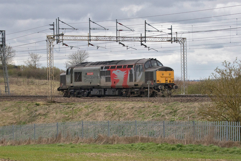 37800, 15.40 Wolverton Centre Sidings-Leicester LIP (7E), between Ashton & Roade 
 Having run down from Leicester to Northampton in the morning to collect a unit and take it to Wolverton, 37800 'Cassiopeia' returns to its base. It does seem rather a waste of resources for the veteran Type 3 to travel a total of one hundred and sixteen miles to drag an EMU, that could have run under its own power (?) just fourteen miles! Unfortunately, I missed the drag in the morning as my wife and I were out for our daily exercise so the returning light engine will have to suffice. 
 Keywords: 0 15.40 Wolverton Centre Sidings-Leicester LIP between Ashton & Roade Cassiopeia Rail Operatins Group ROG Pheonix