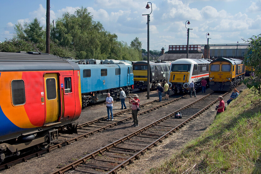 156498, E3035, 91117, 89001 & 66726, on display, Barrow Hill 
 The central bank at Barrow Hill affords good views of the depot lines and is always popular with photographers. Seen in this view, from left to right, is EMR's 156498, AC LG's E3035 (83012) & 89001 'Advocet', with 91117 sandwiched between. Finally, on the end is local celebrity GBRf's 66726 'Sheffield Wednesday'. 
 Keywords: 156498 E3035 91117 89001 66726 on display Barrow Hill EMR East Midlands Railway Advocet Sheffield Wednesday