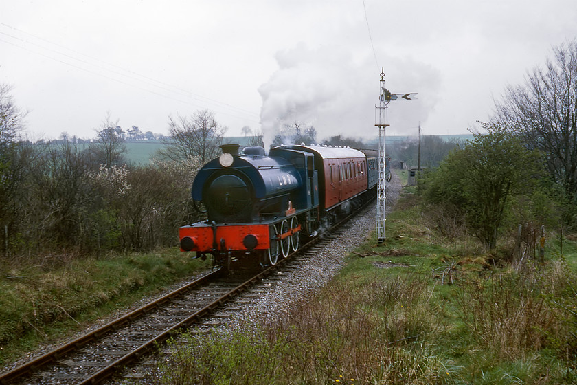 196, 12.00 Ropley-New Alresford, Bishop's Sutton SU596324 
 We walked east along the route of the line from New Alresford to a point close to where the A31 went under the track. 196 'Errol Lonsdale' approaches with the 12.00 Ropley to New Alresford hauling a trio of mixed stock in three different liveries. With its 4ft 3ins driving wheels the locomotive looks purposeful and these helped towards its designed specification to get a train of over one thousand tons away on level track. 
 Keywords: 196 12.00 Ropley-New Alresford Bishop's Sutton SU596324 Watercress Line Mid Hants Railway Errol Lonsdale