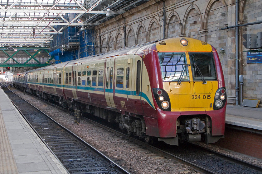 334015, unidentified working, Edinburgh Waverley station 
 Still wearing its Strathclyde Partnership for Transport livery that is being replaced by the Transport Scotland blue Saltaire paint scheme 334015 is seen standing in Waverley station with an unidentified service. These units look good in either livery but there is no doubt that the newer livery revives these decade-old units. 
 Keywords: 334015 unidentified working Edinburgh Waverley station ScotRail