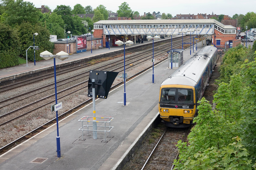 165130, GW 16.13 Newbury-Reading (2K73), Newbury station 
 Taken from the A339 road bridge at the eastern end of Newbury station the layout is seen prior to the installation of the wiring and replacement of the lovely Great Western footbridge. 165130 waits in the bay platform to work the 16.13 to Reading local stopper service. When (if ever?) the wires arrive this scene, that has essentially been the same for over 100 years, will change forever. 
 Keywords: 16513016.13 Newbury-Reading (2K73), Newbury station