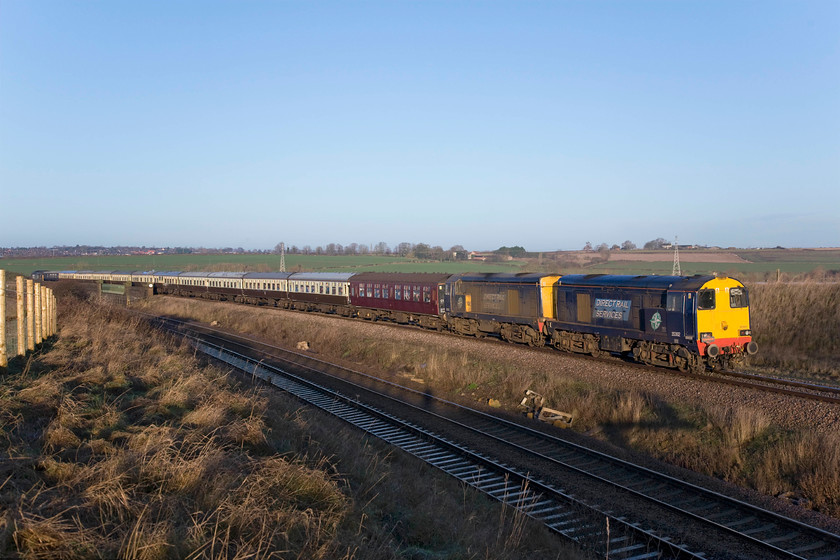 20302, 20305 & 37194 outward leg of The Deviatoner, 06.22 Crewe-Ely Papworth Sidings (1Z20), Irchester Junction SP922673 
 Taking the bi-directional slow line The Deviatoner railtour begins the climb towards to Sharnbrook summit having just crossed the Nene Valley just south of Wellingborough. With 20302 and 20305 running in their usual nose to nose formation 37194 brings up the rear. Unfortunately, towards the end of the day after some convoluted moves, the Class 37 failed with a burst coolant pipe thus meaning some 'wrong line' running at Trent Junction in the evening. 
 Keywords: 20302 20305 37194 The Deviatoner 06.22 Crewe-Ely Papworth Sidings 1Z20 Irchester Junction SP922673 Pathfinder Tours