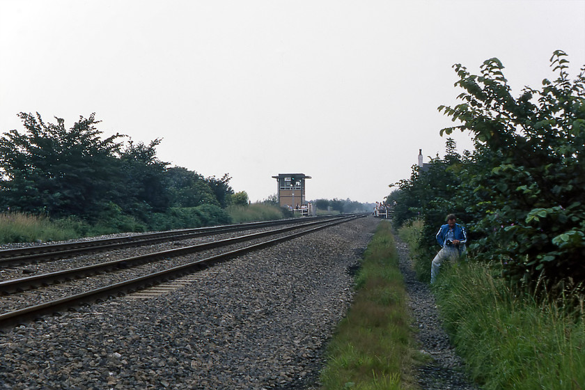 Astley signal box (BR, 1972) SJ704972 
 In the distance, Astley signal box is seen at a manually operated level crossing that remains closed to traffic unless a vehicle wishes to cross the line. This is the second box at this location the first one being slightly nearer to the camera. This 1972 BR Type 15 2h box is still in use today (2020) containing a fifteen lever frame. Until 1956 there was also a station at this remote location on Chat Moss. I am sure that we were in full view of the signalman on duty this particular day but it did not stop us getting away from the crowds at the crossing itself waiting for the passage of the steam special. 
 Keywords: Astley signal box SJ704972 Chat Moss