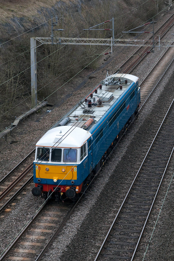 86259, 12.40 Acton CS Rugby CS LE (0Z88), Roade Cutting 
 Following railtour duties the previous day, 86259 'Peter Pan/Les Ross' heads light engine from Acton to Rugby carriage Sidings. During the week, this veteran class 86 that emerged from Doncaster Works in 1966, can often be seen stabled just outside Rugby station in the overgrown carriage sidings. 
 Keywords: 86259 12.40 Acton CS Rugby CS 0Z88 Roade Cutting